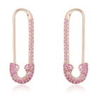 Gold-plated safety pin earrings with pink gemstones from our exclusive jewelry collection.