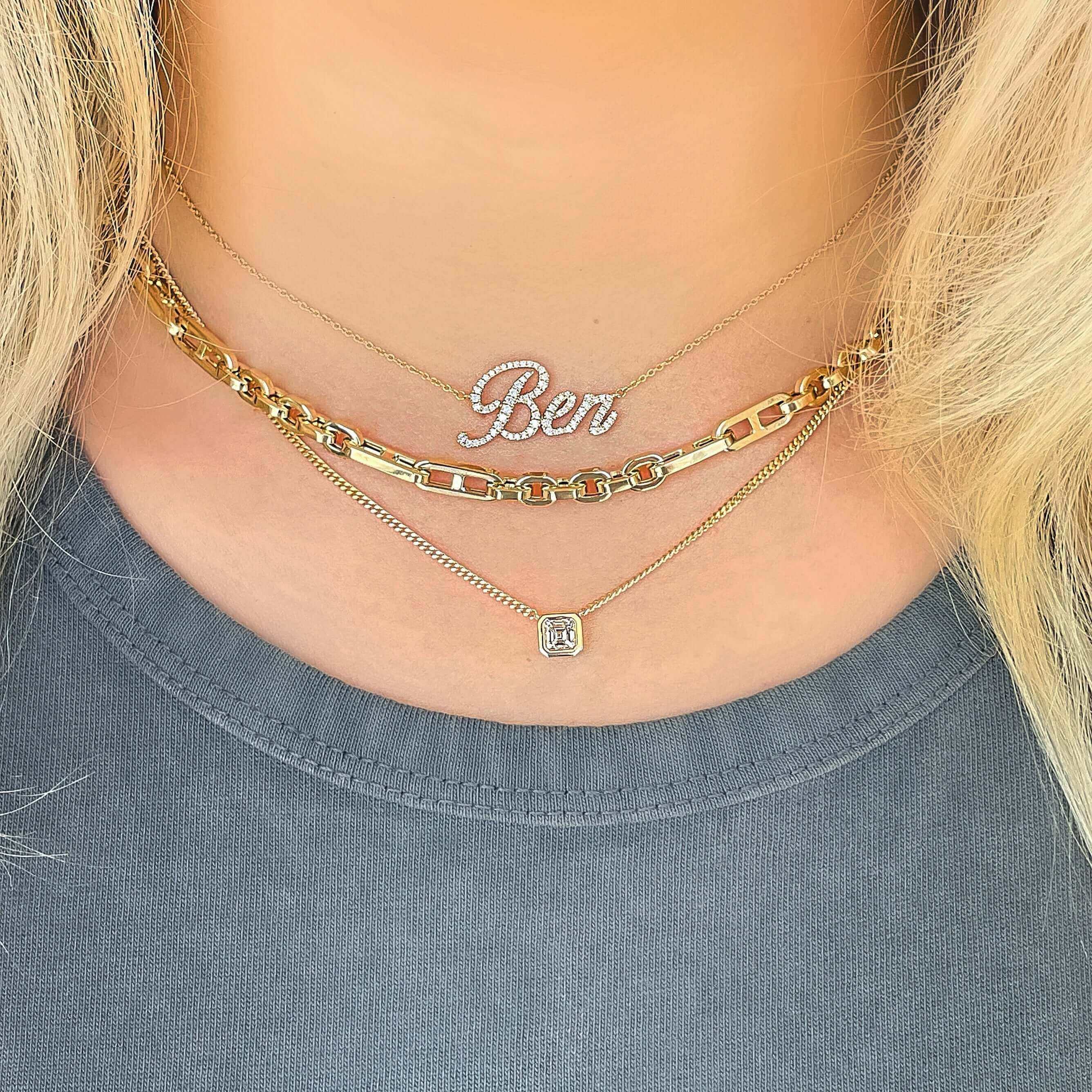 Layered gold necklaces with personalized "Ben" pendant and diamond charm from our exclusive jewelry collection.