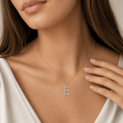 Model wearing a Multi Shape Diamond Initial Pendant in gold, featuring an elegant diamond 'E' design.