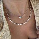 Multi Shape Lab Diamond Necklace on a model, showcasing pear and heart lab-grown diamonds in gold setting.