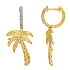 Gold palm tree drop earrings with diamond accents from our jewelry collection.