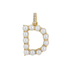 Gold pendant adorned with pearls in the shape of letter D.