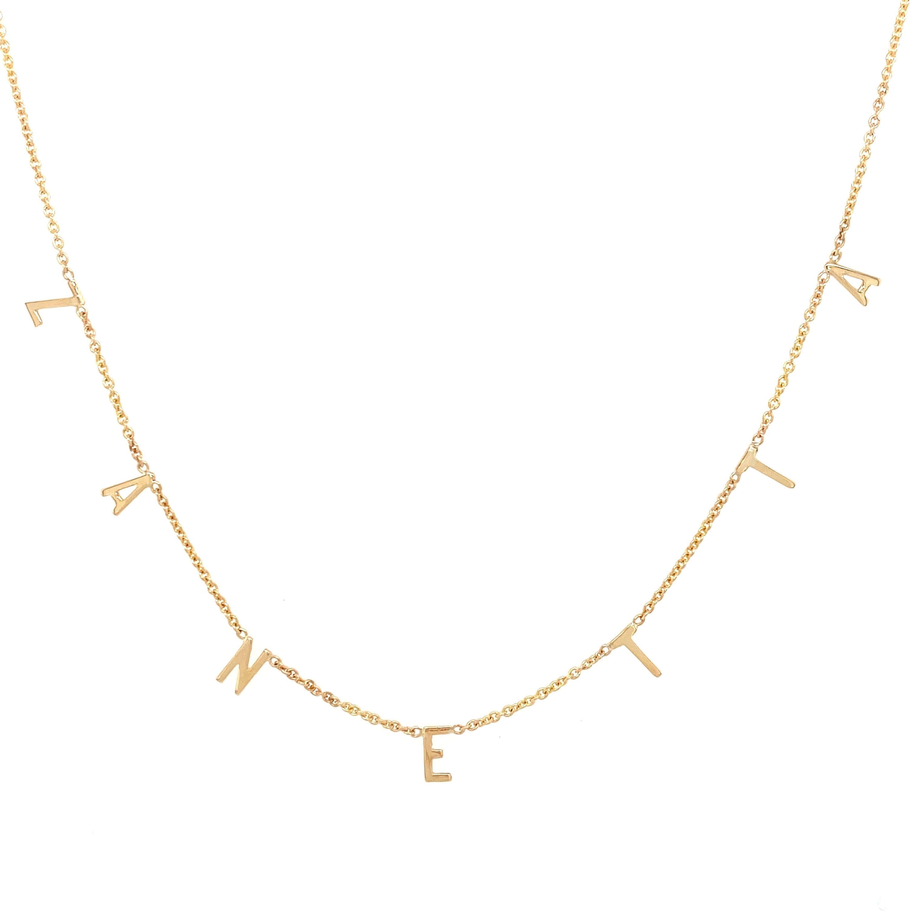 Gold necklace with custom letter pendants from our jewelry brand, perfect for personalized elegance and unique style.