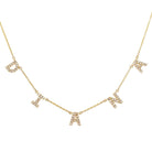 Gold necklace with diamond-studded custom letter charms in a delicate chain from our luxury jewelry collection.