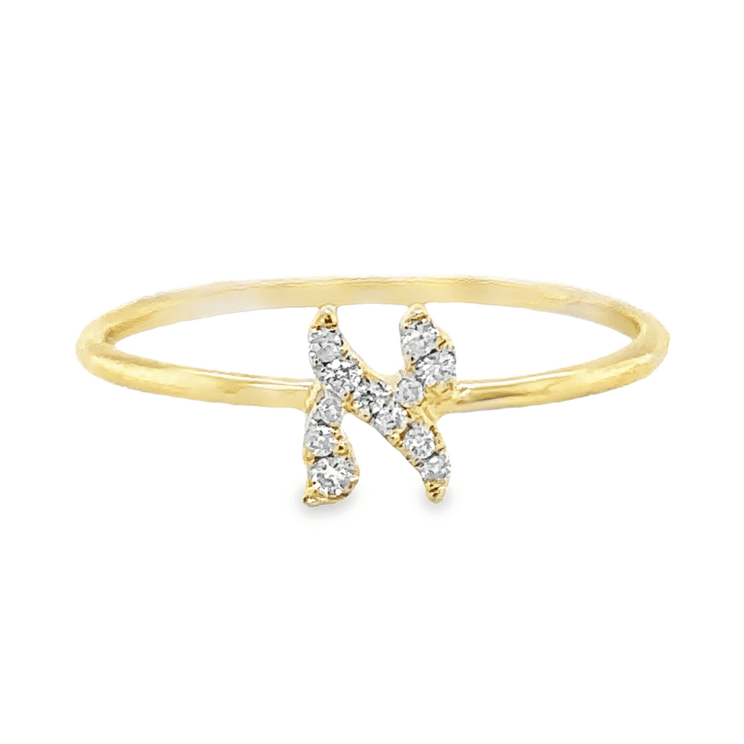 Gold ring with diamond-studded initial N, delicate design from our luxury jewelry collection. Ideal for personalizing any outfit.