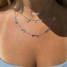 Woman wearing layered personalized silver name necklaces from our jewelry brand