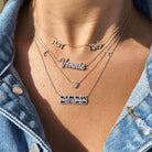 Woman wearing layered personalized name necklaces from our jewelry collection, adding a touch of elegance to her outfit.