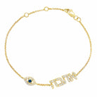 Gold bracelet with evil eye charm and "Love" motif, featuring sparkling gemstones.