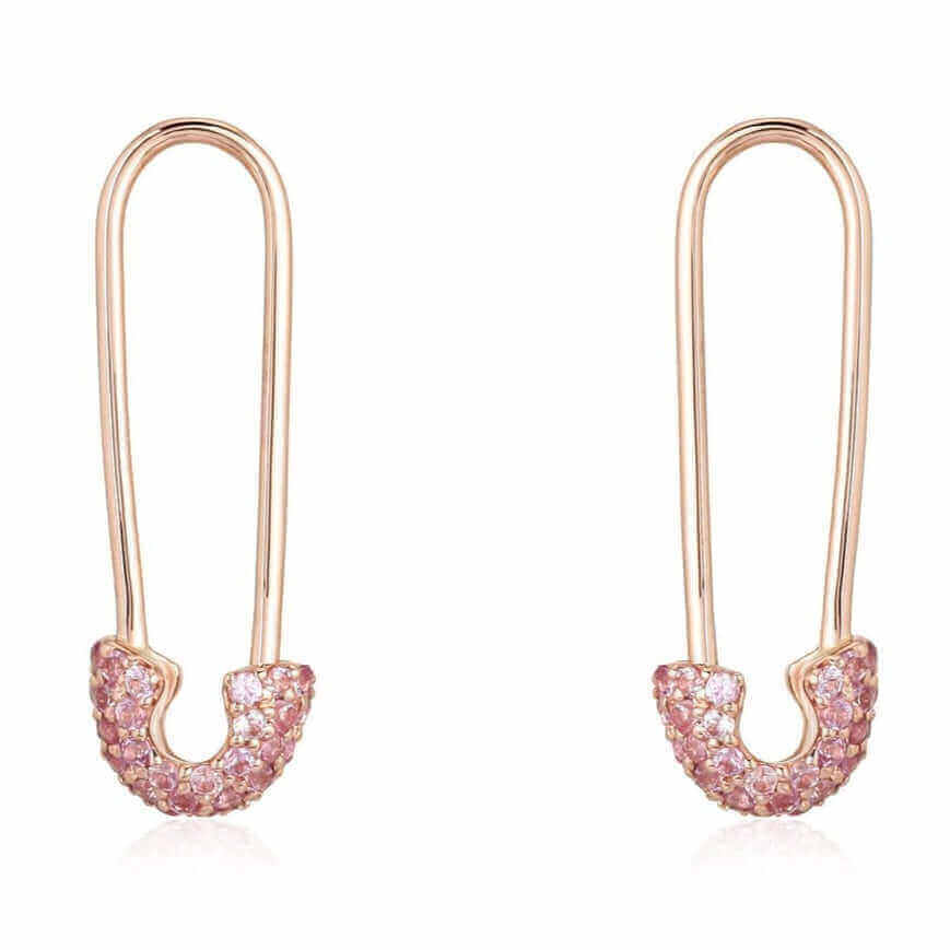 Elegant gold earrings with pink gemstones in a unique safety pin design from our exclusive jewelry collection.