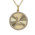 Gold initial pendant necklace with letter 'L', diamond embellishments, and sunburst design background.