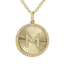 Gold pendant necklace with letter M and diamond accents on a jewel-inspired chain