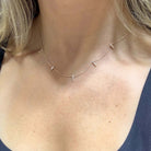 Spike Stations Diamond Necklace showcased on a woman's neck, featuring gold spikes with diamonds from Izakov Fine Jewelry.