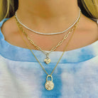 Layered gold necklaces with lock and heart pendants from our jewelry brand, perfect for adding a stylish and unique touch to any outfit.