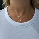 14K gold Star of David necklaces worn together on a model, showcasing faith and elegance in a casual outfit.