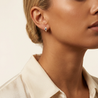 Micro Pave Diamond Blue Evil Eye Huggie Earrings — model shot