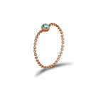 18K gold chain ring with a blue birthstone, perfect for personal significance and elegant jewelry collections.