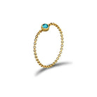 18K gold birthstone chain ring with a blue gemstone, elegant jewelry gift for special occasions.