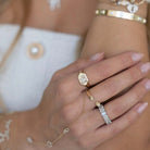 Close-up of a hand wearing a Hebrew Chai Baguette Diamond Signet Ring from Izakov Fine Jewelry.