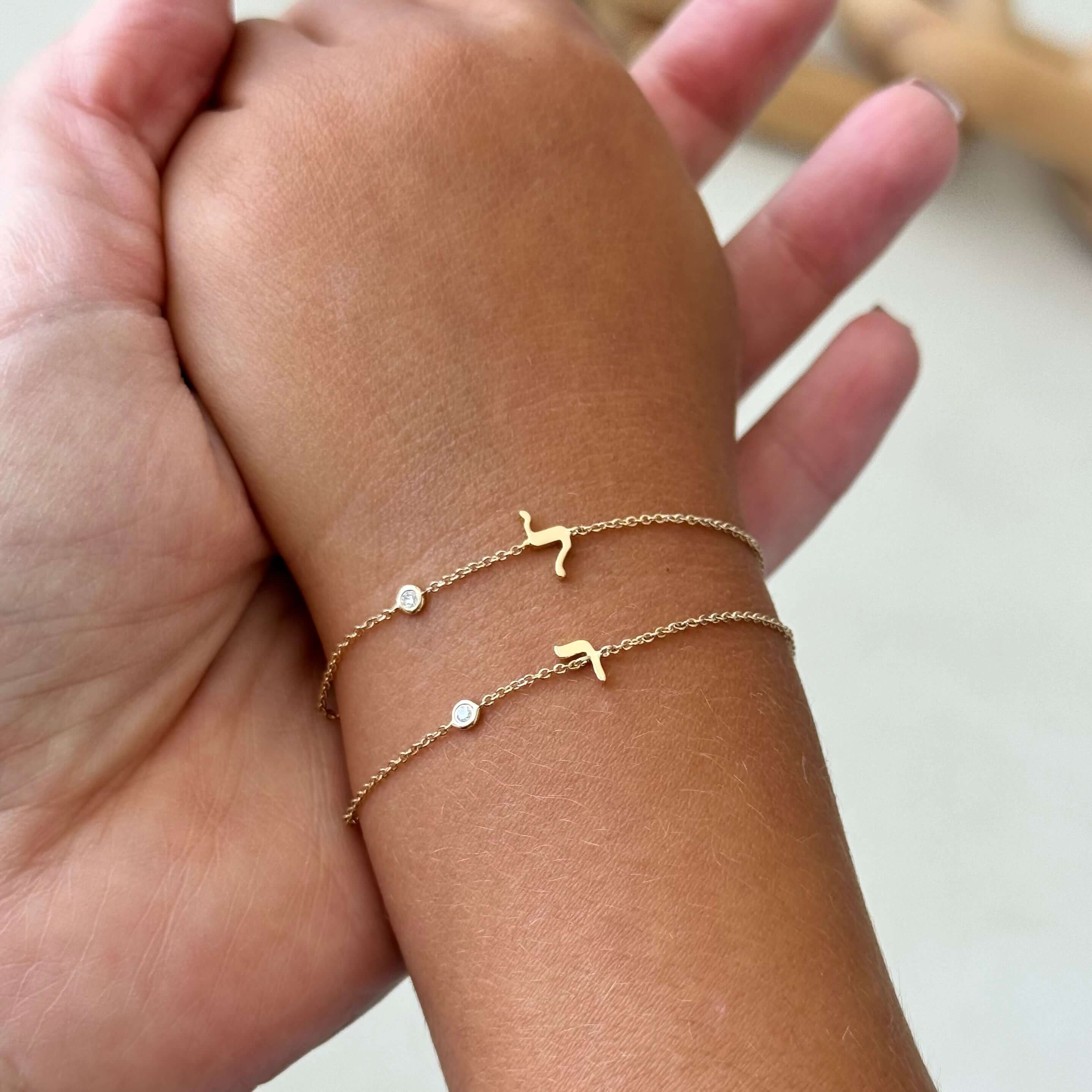 14K Gold Mini Hebrew Initial Gemstone Bezel Bracelet showcasing delicate design with personalized initials and birthstones.