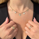Heart Charms Beaded Ball Diamond Necklace with gold heart charms and beaded chain displayed on a person's neck.