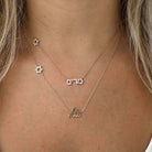 Diamond Motif Personalized Script Nameplate Necklace featuring a gold nameplate and star motifs.