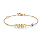 Gold bracelet with 'PENNY' and a purple gemstone on a white background