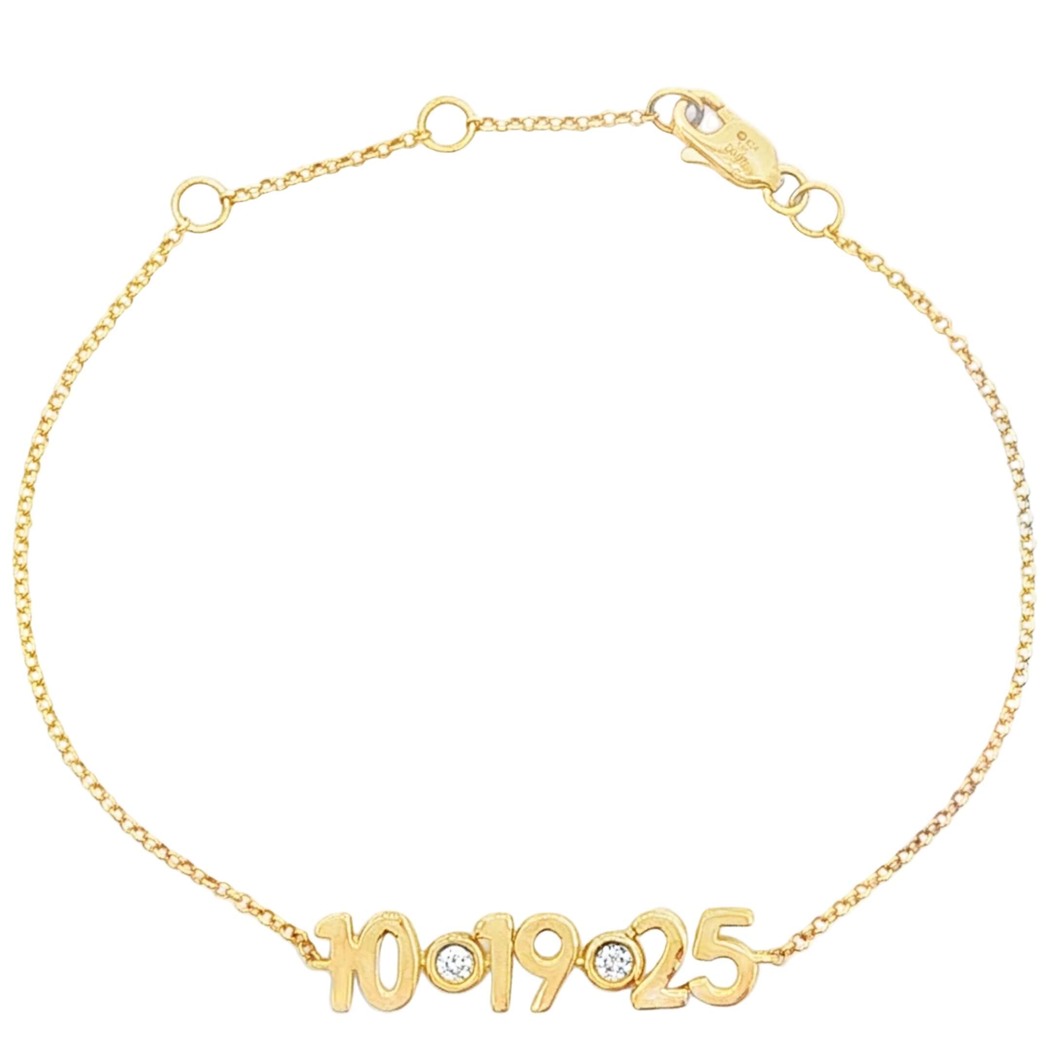 Gold bracelet with '10 19 25' engraving on a white background