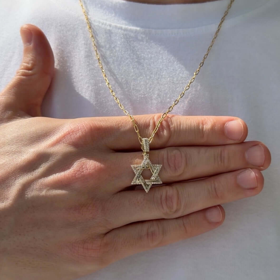 Baguette & Round Diamond Star of David Pendant displayed on a person’s hand, showcasing the intricate diamond arrangement.
