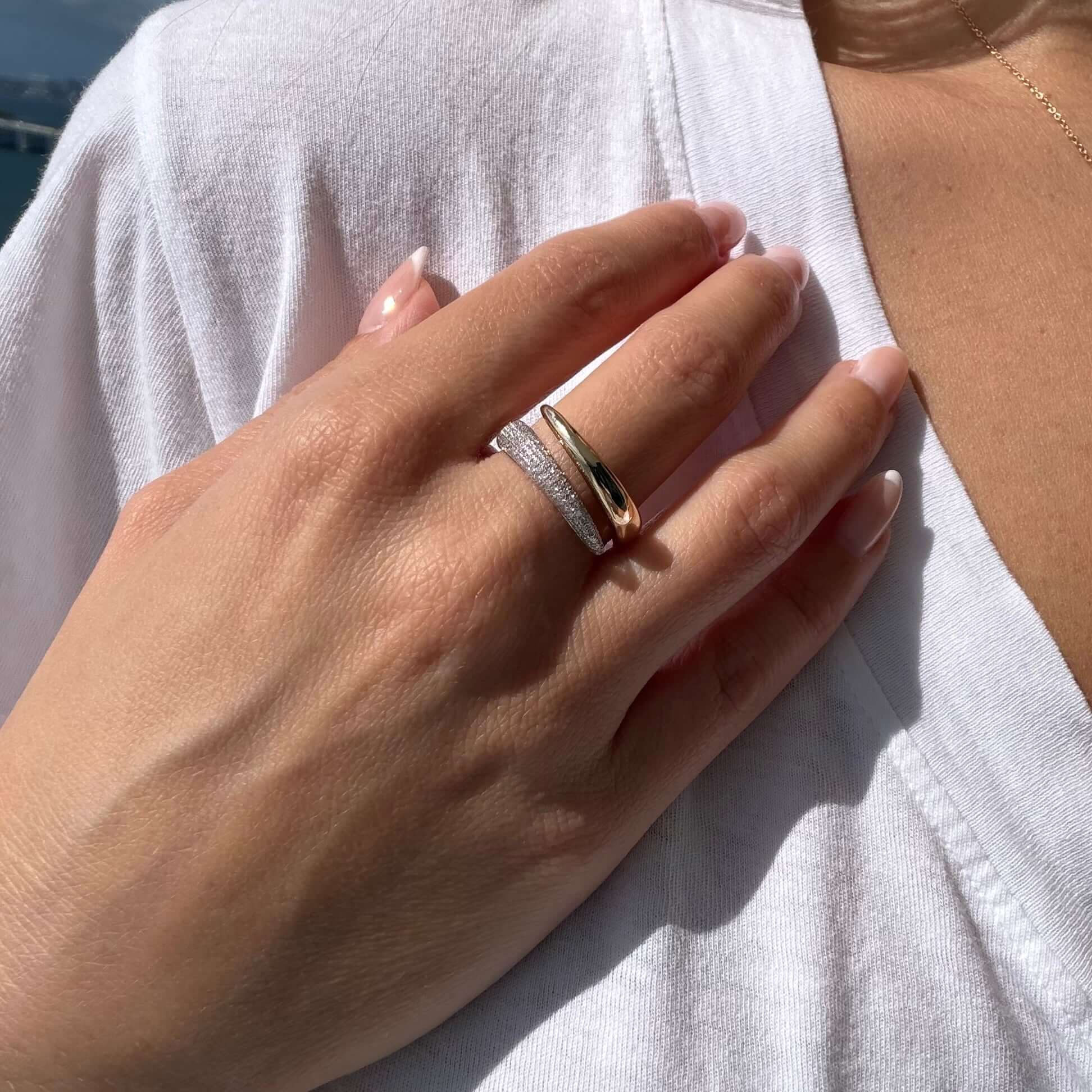 Diamond Pavé Split Wrap Ring worn on a woman's hand, featuring gold and pavé diamond details in a modern design.