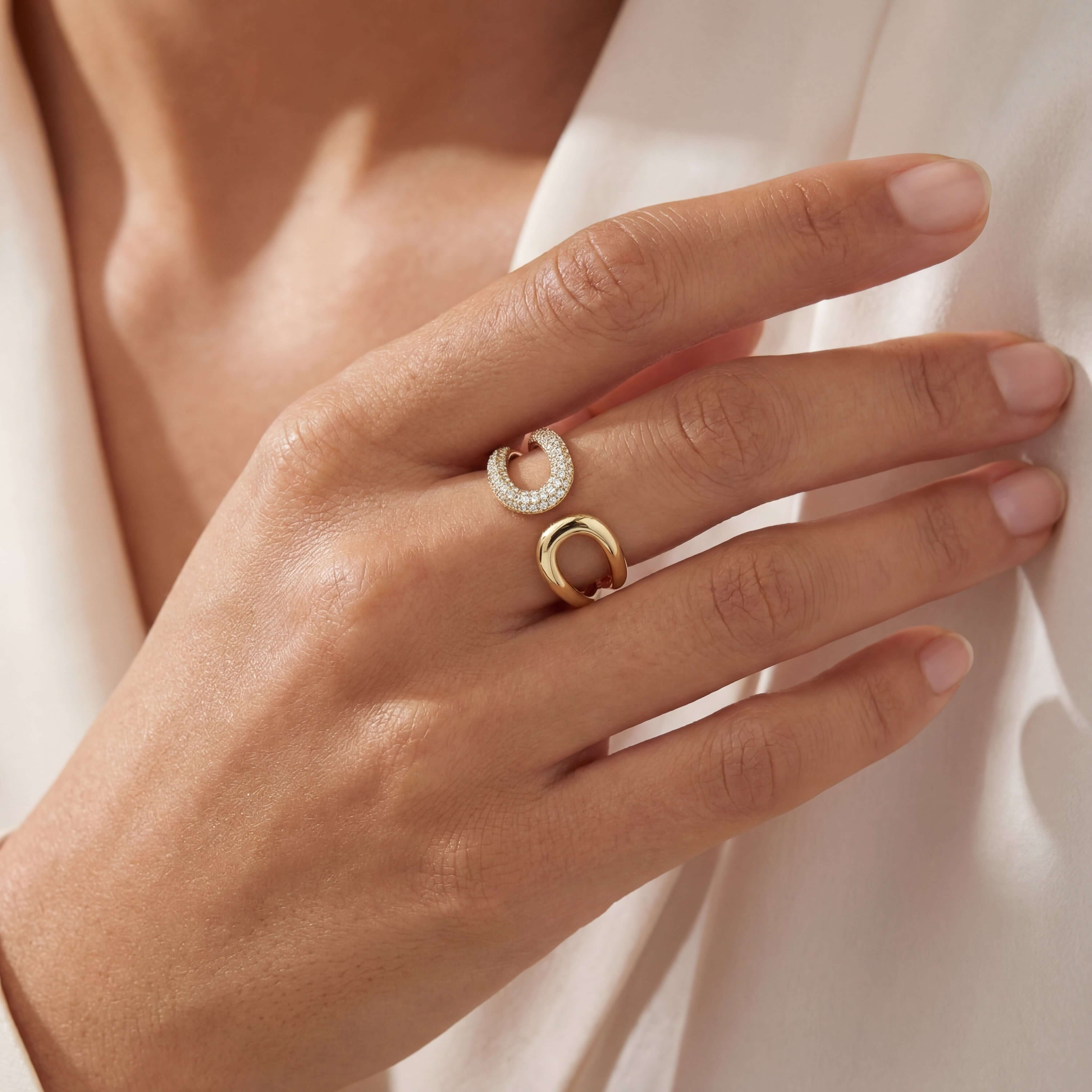 Double Loop Diamond Wrap Ring showcased on a woman's hand, featuring polished gold and micro pavé diamonds.