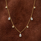 Pear and Round Lab Diamond Dangle Necklace in 14K yellow gold, styled, Izakov Fine Jewelry