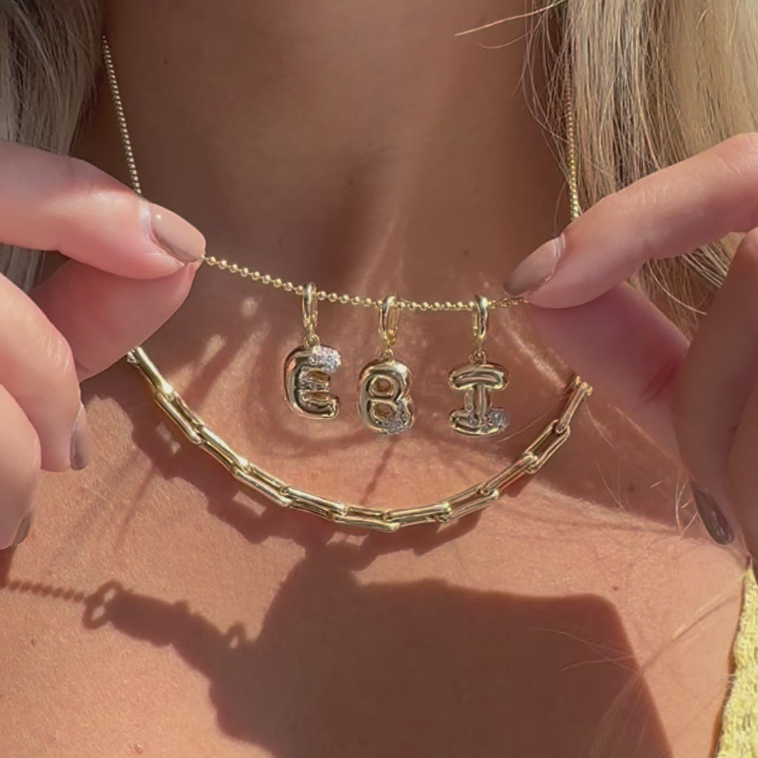 14K Gold Bubble Letter Diamond Necklace Charm with diamond-accented letters EBI on a delicate chain.