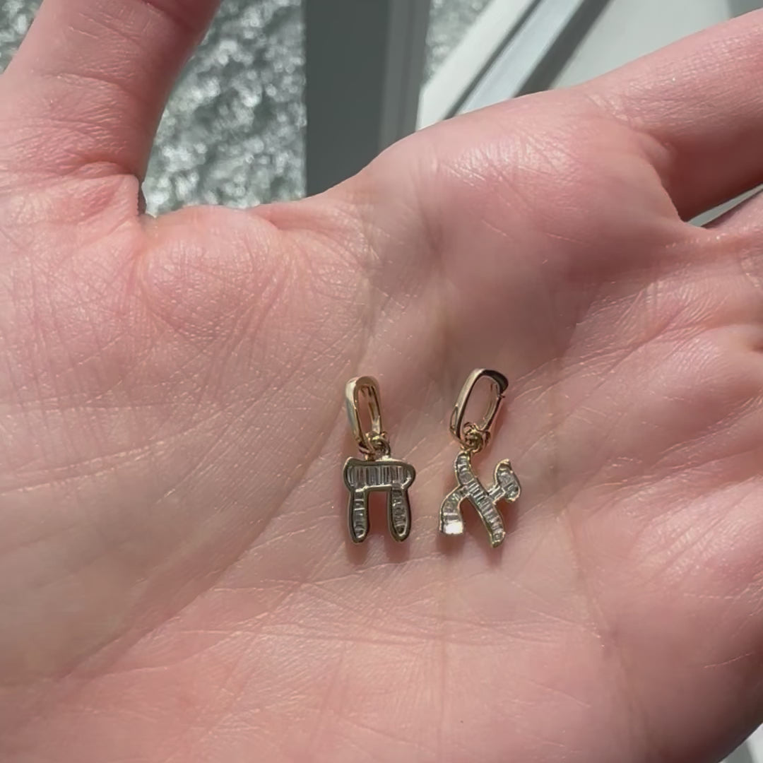 14K Gold Baguette Diamond Hebrew Initial Necklace Charm displayed in a palm, showcasing Hebrew letters and diamond accents.