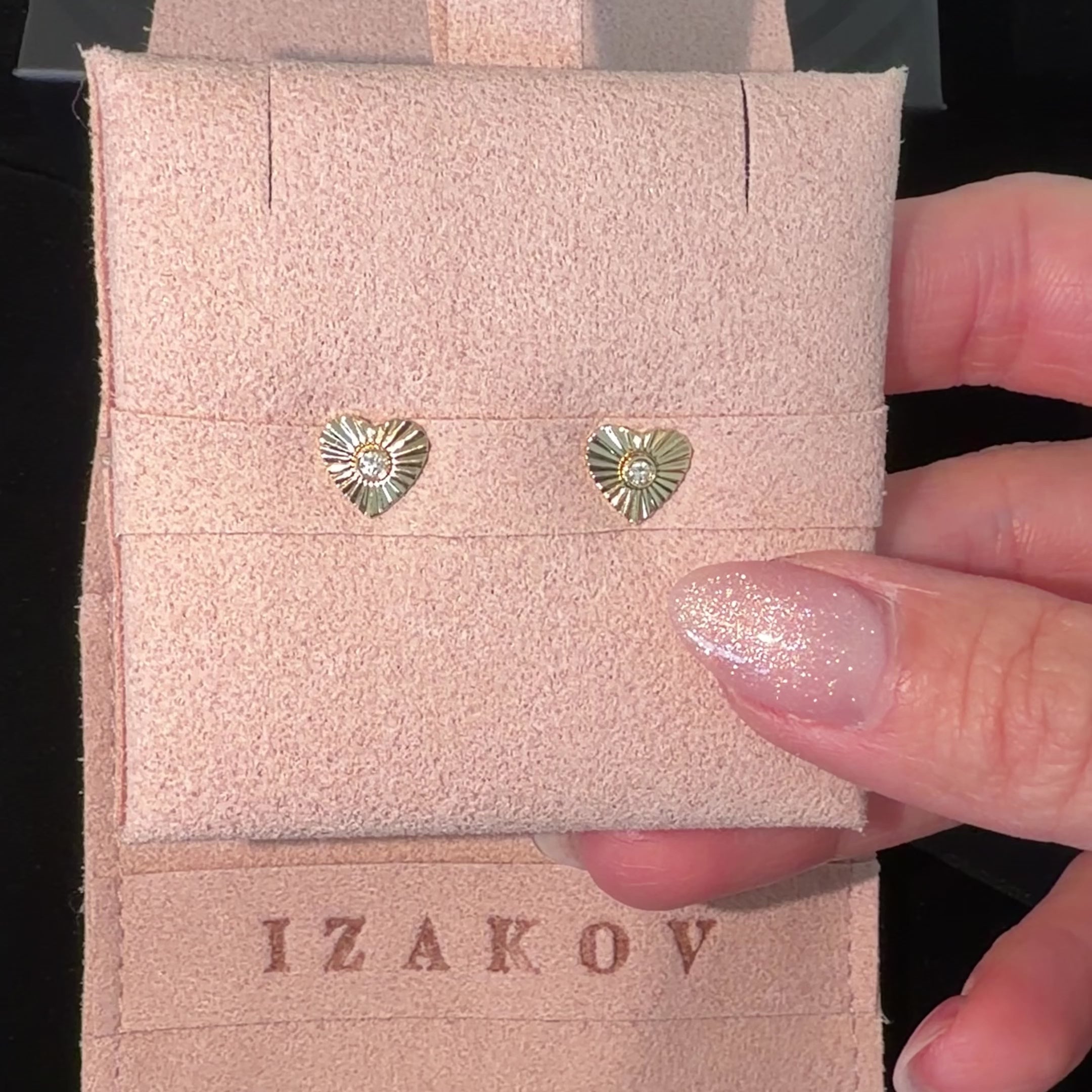Radiating Diamond Heart Stud Earrings in 14k gold displayed in an Izakov Fine Jewelry pouch.