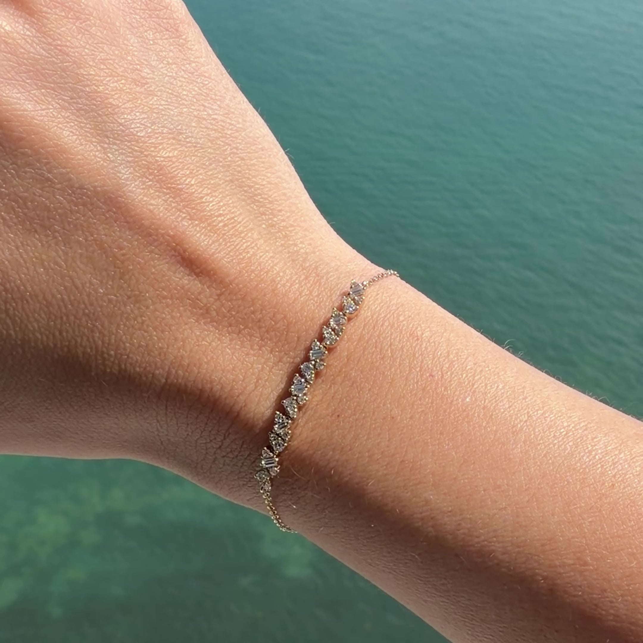 Baguette & Round Diamond Cluster Bracelet worn on a wrist, showcasing its elegant cluster design in 14k gold.