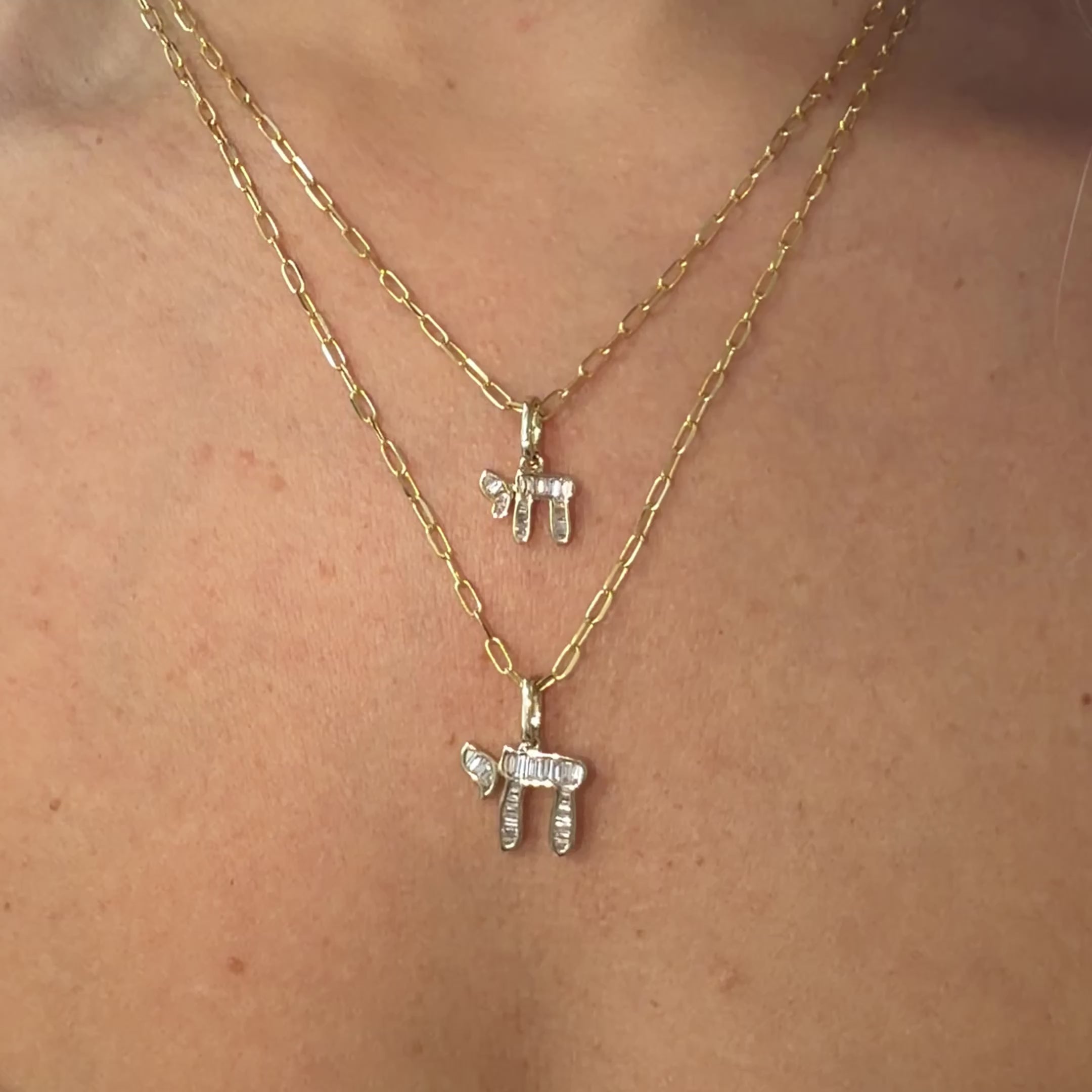 14K Gold Hebrew Chai Baguette Diamond Necklace Charm on layered chains, showcasing small and medium sizes.