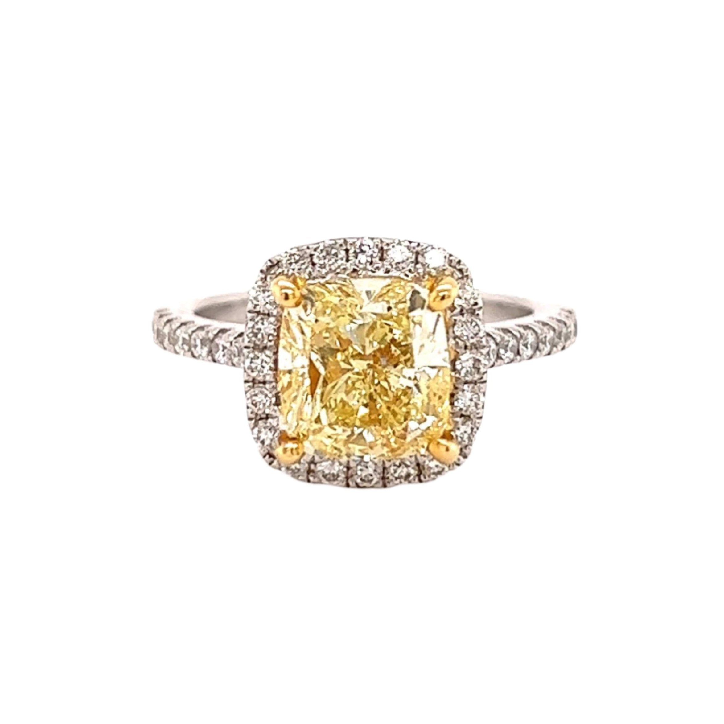 Luxurious yellow diamond engagement ring with a halo setting and pave band from our exclusive jewelry collection.